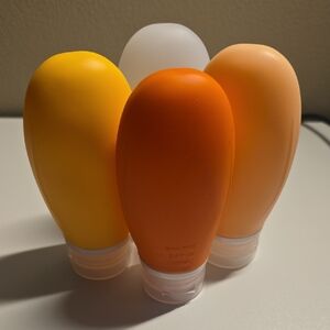 Set of Travel Bottles in Yellow, Orange, and White